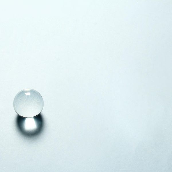 Abstract blue and white glass sphere reflecting light